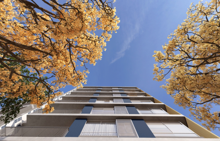 Fachada do empreendimento MOVA.WF vista de baixo, com arquitetura contemporânea integrada à paisagem urbana e árvores ao redor, em Curitiba.